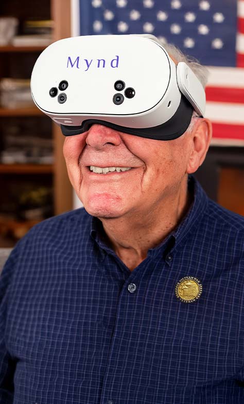 Elderly man wearing a white VR headset