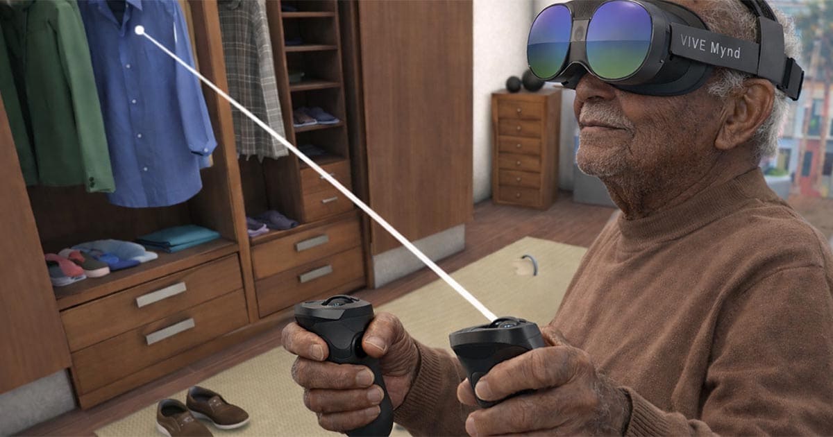 An older man wearing a VIVE Mynd VR headset and holding controllers interacts with a virtual wardrobe, selecting an item with a light beam.
